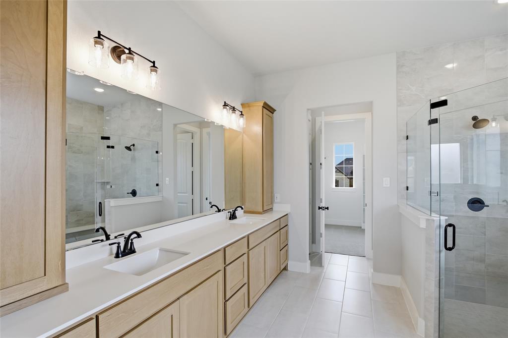 812 Vly Rdg Road Van Alstyne, TX 75495 - Photo 16 of 33 a bathroom with a double vanity sink mirror and shower