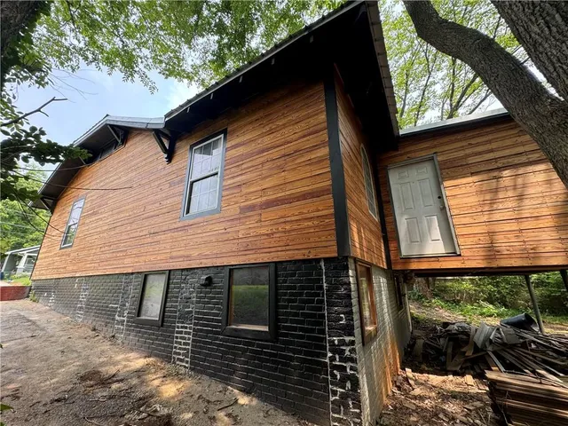 a side view of a house with a yard