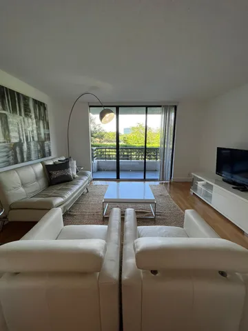 a living room with couches and a flat screen tv