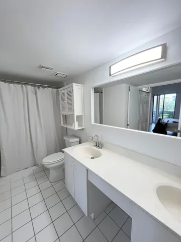 a spacious bathroom with a double vanity sink and a mirror