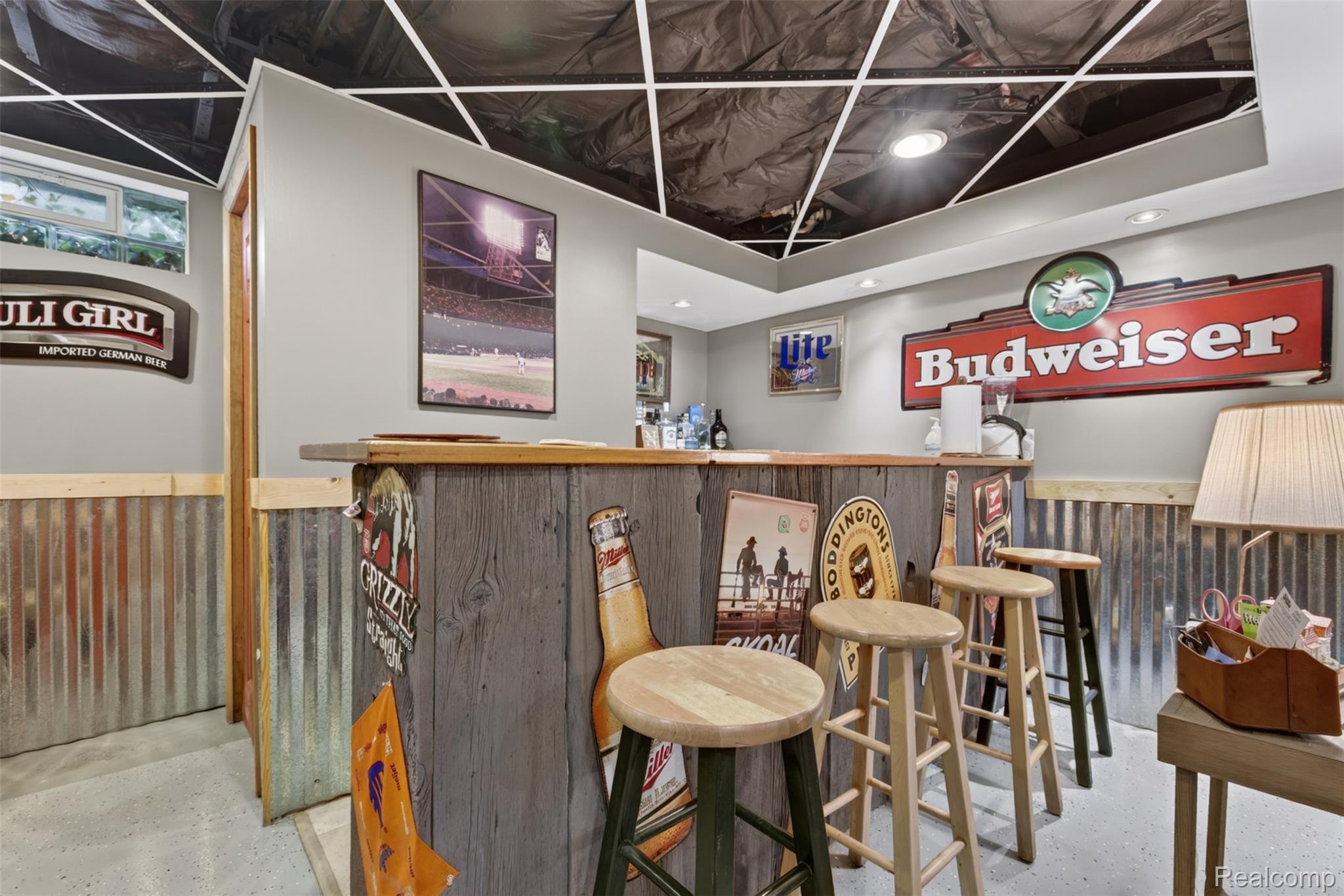5977 Anglers Road Ortonville, MI 48462 - Photo 29 of 63 Custom bar area featuring a wood-finish countertop and corrugated metal wainscoting