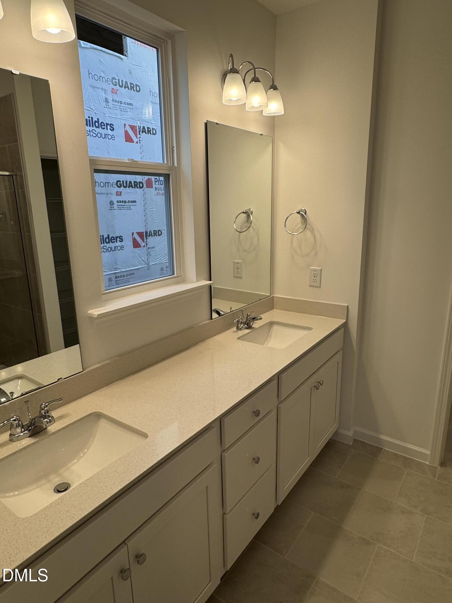128 Vulcan Street Garner, NC 27529 - Photo 14 of 28 a bathroom with a double vanity sink and a mirror