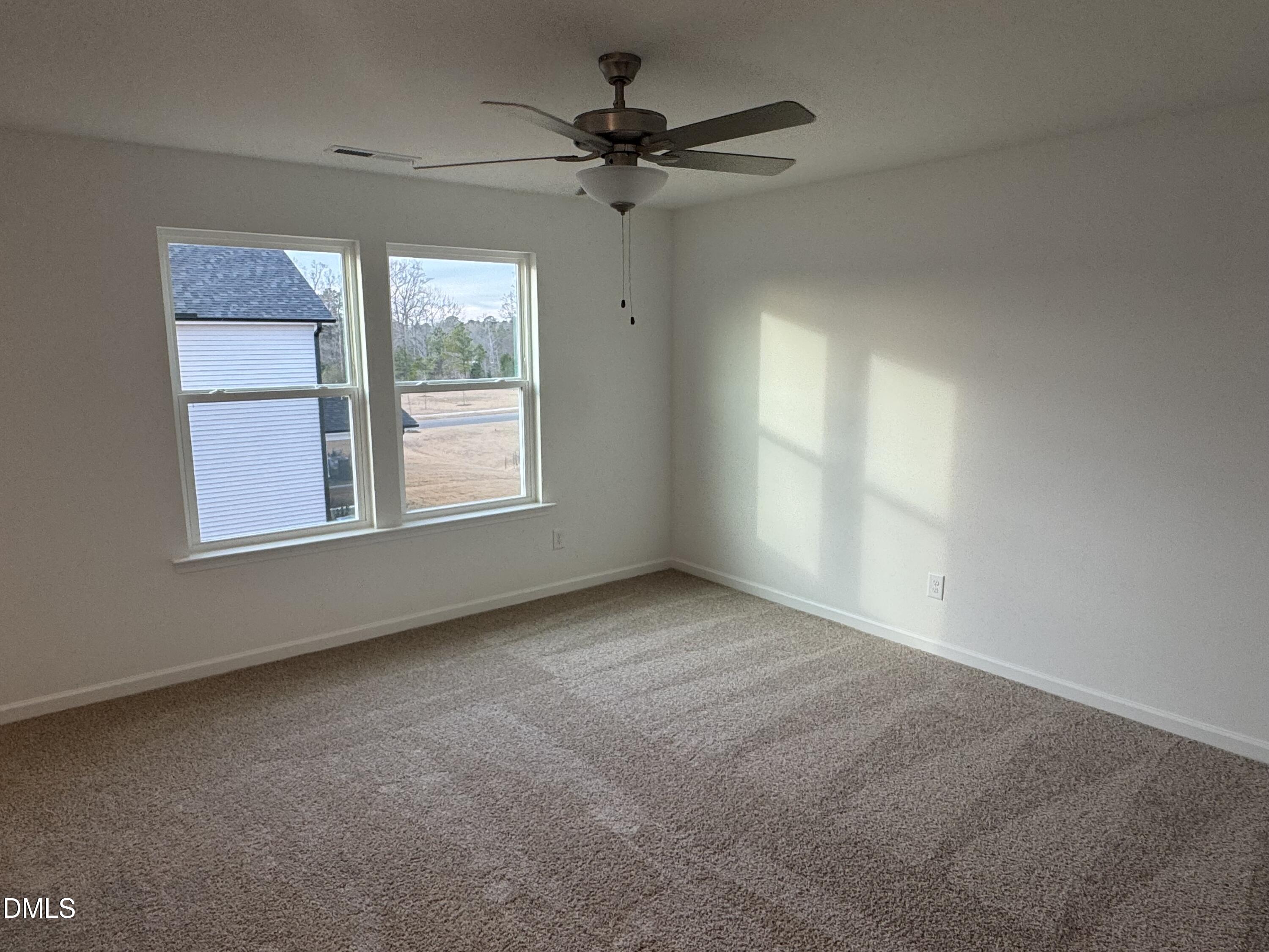 128 Vulcan Street Garner, NC 27529 - Photo 19 of 28 an empty room with windows and ceiling fan