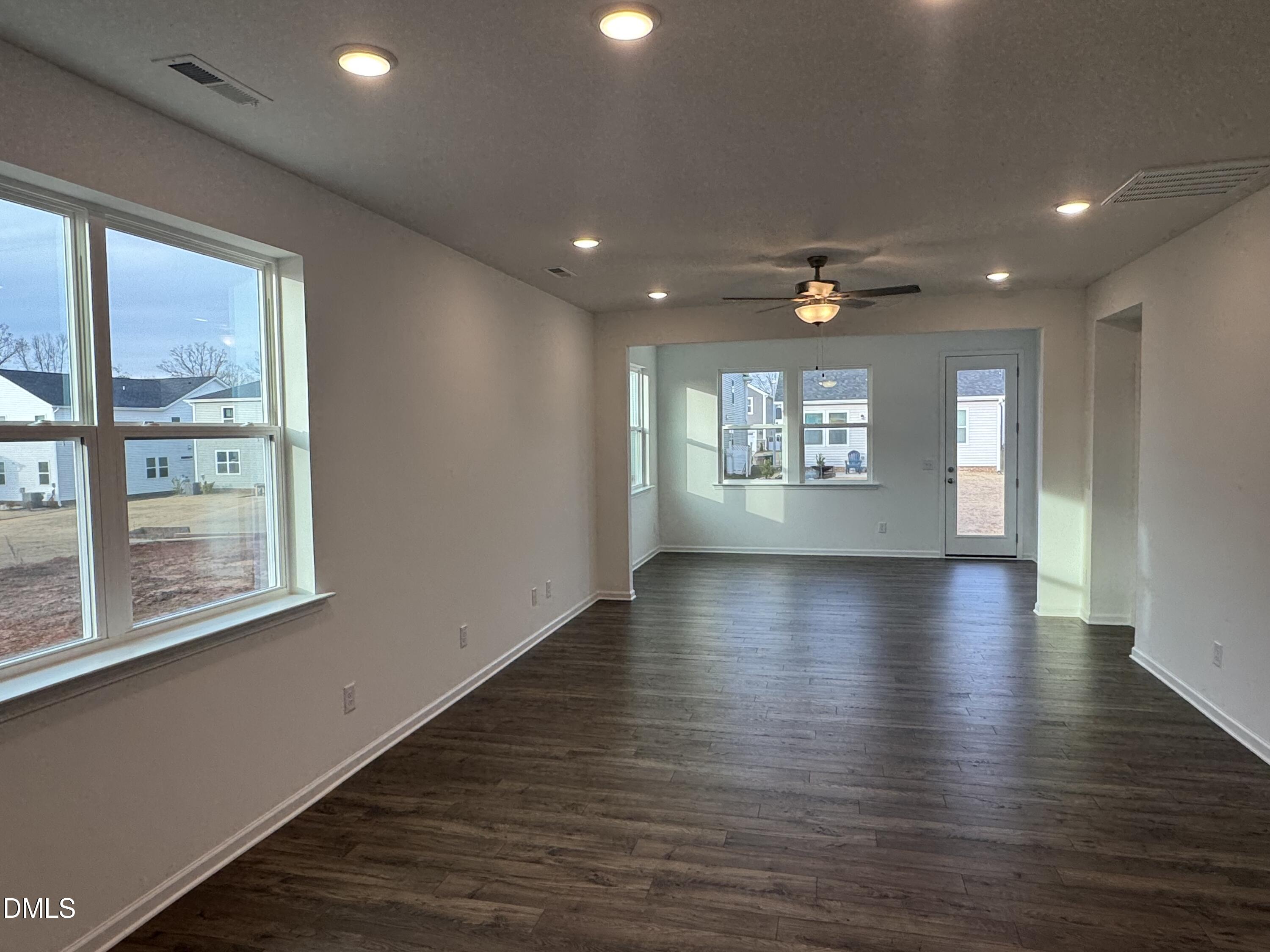 128 Vulcan Street Garner, NC 27529 - Photo 8 of 28 an empty room with wooden floor and windows
