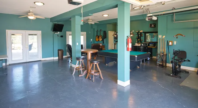 a living room with furniture and a floor to ceiling window