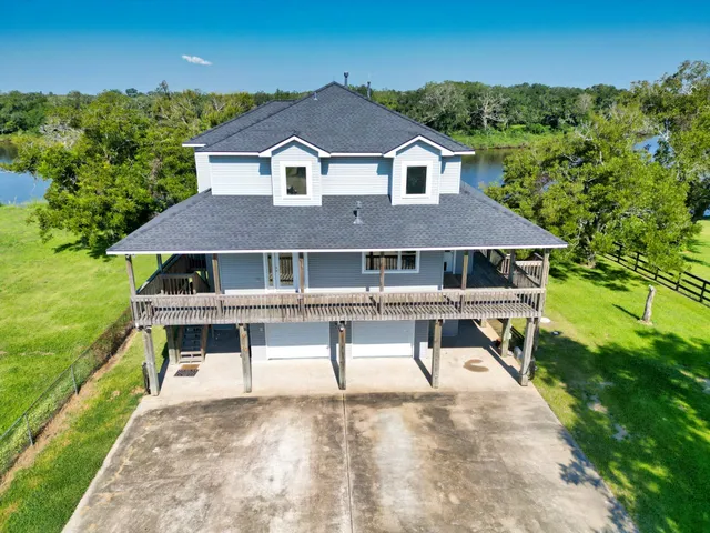 a aerial view of a house with a yard and potted plants