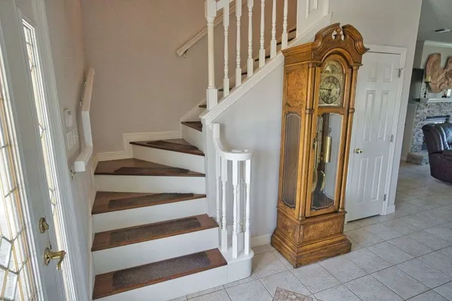 an aerial view of a house with a yard and lake view