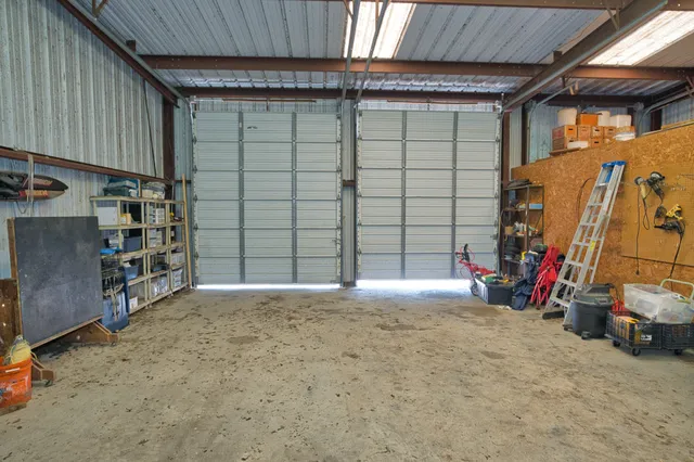 a front view of a house with a yard and potted plants