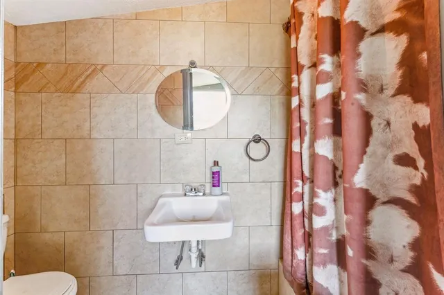 a living room with furniture a ceiling fan and a rug