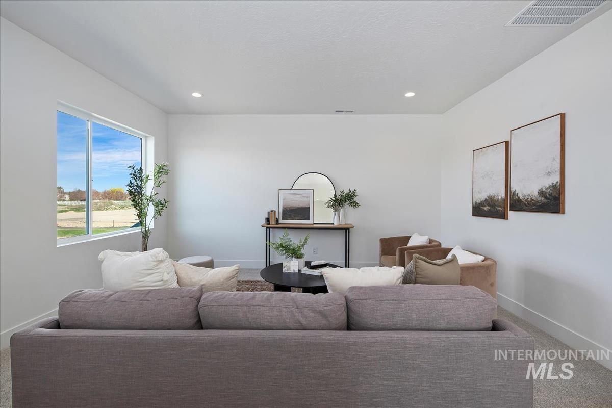 749 South Calhoun Lane Star, ID 83669 - Photo 7 of 34 Carpeted living area featuring baseboards and recessed lighting