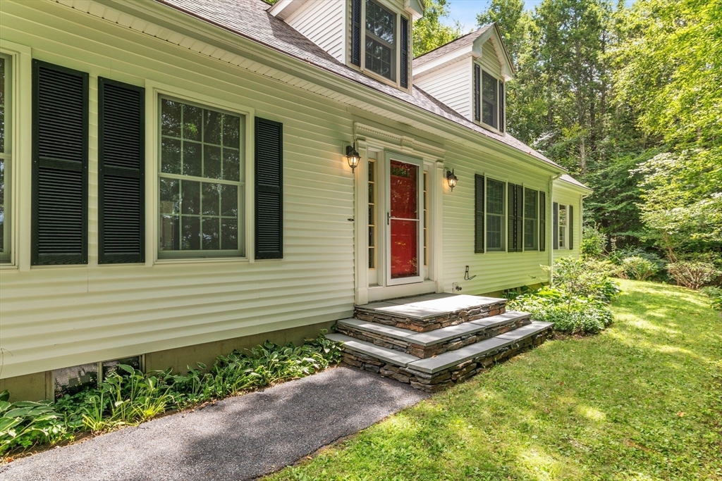17 Church Road Huntington, MA 01050 - Photo 1 of 36 a view of a house with potted plants and a bench in front of door