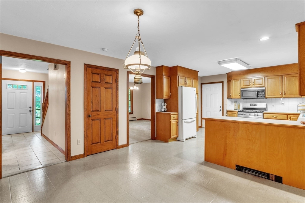 17 Church Road Huntington, MA 01050 - Photo 13 of 36 a open kitchen with stainless steel appliances granite countertop a refrigerator a oven and a sink