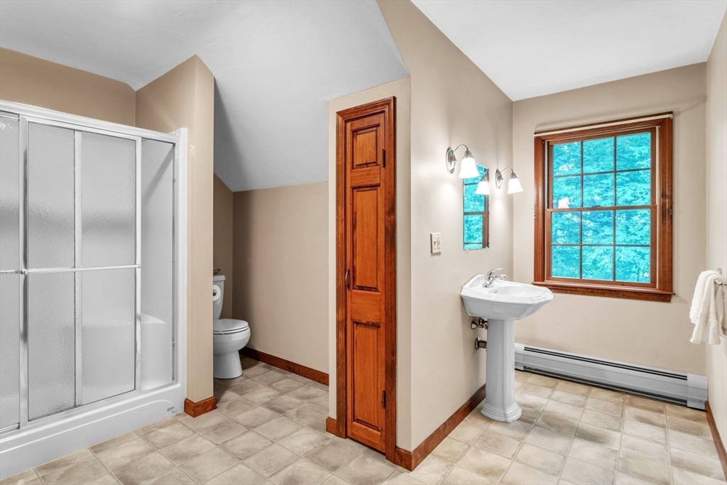 17 Church Road Huntington, MA 01050 - Photo 21 of 36 a bathroom with a granite countertop sink a toilet and shower