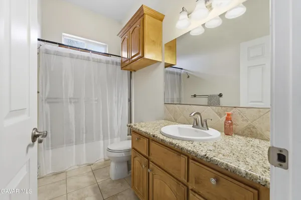 a spacious bathroom with a sink a mirror and a vanity