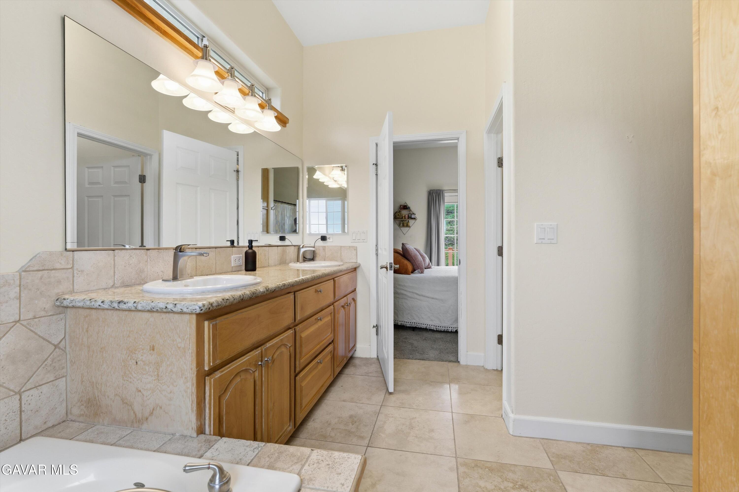 20000 Brite Valley Road Tehachapi, CA 93561 - Photo 12 of 32 a spacious bathroom with a sink a mirror and a vanity