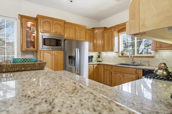 a kitchen with a refrigerator sink and stove
