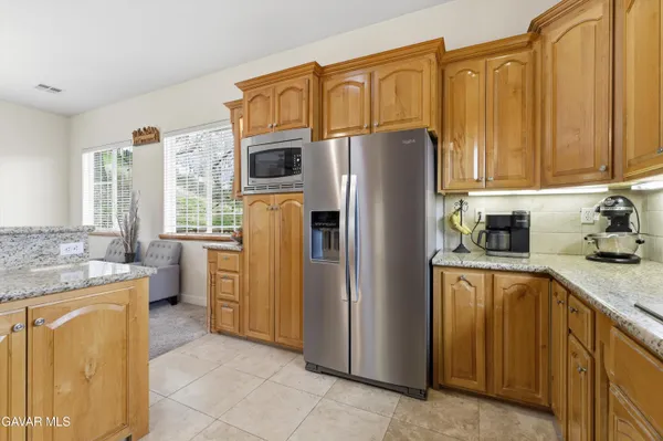 a kitchen with a refrigerator a stove top oven a sink and dishwasher with wooden floor