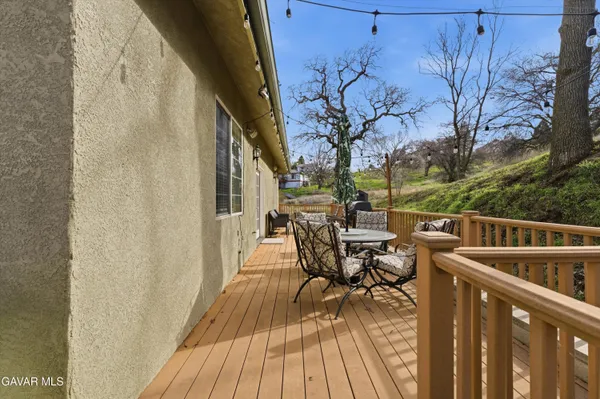 a balcony with wooden floor and furniture
