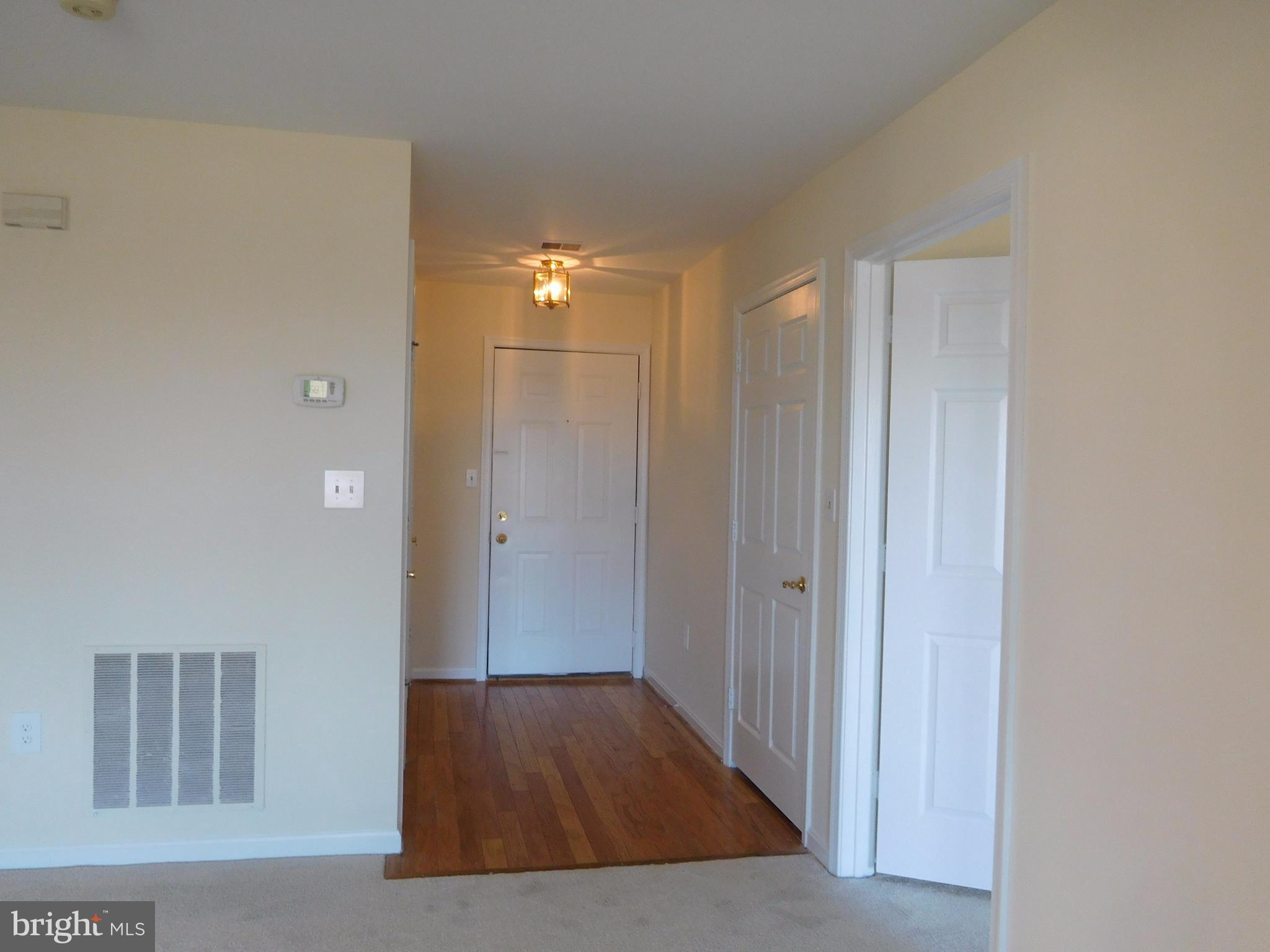 304 Ridgepoint Place, Unit 14 Gaithersburg, MD 20878 - Photo 2 of 25 a view of hallway with wooden floor