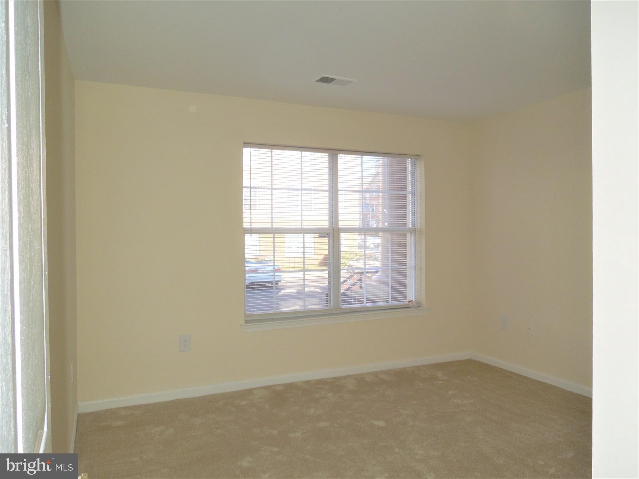 304 Ridgepoint Place, Unit 14 Gaithersburg, MD 20878 - Photo 14 of 25 an empty room with a window