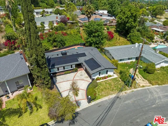 an aerial view of a house with a garden and swimming pool
