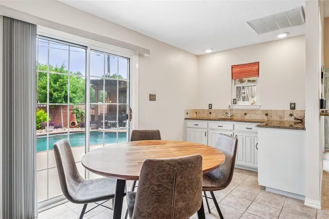 a dining room with a table and chairs