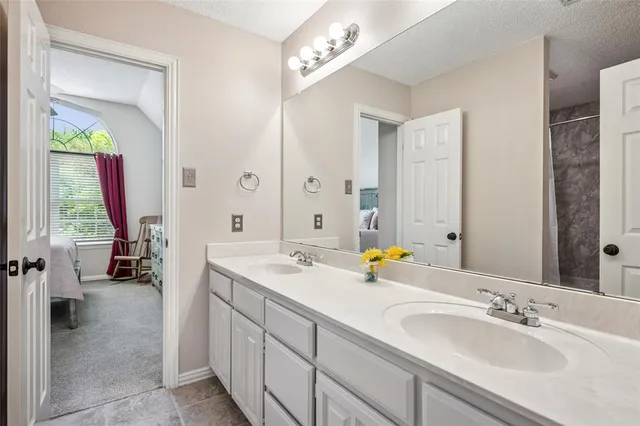 a bathroom with a sink double vanity and a mirror