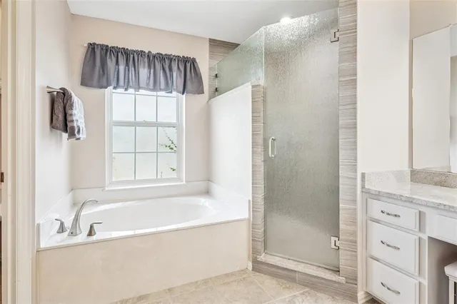 a bathroom with a bathtub and a shower