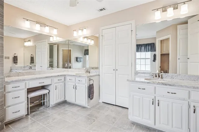 a spacious bathroom with a granite countertop sink mirror and