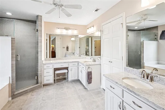 a bathroom with a granite countertop sink mirror and shower