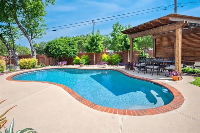 a view of a swimming pool with an outdoor seating