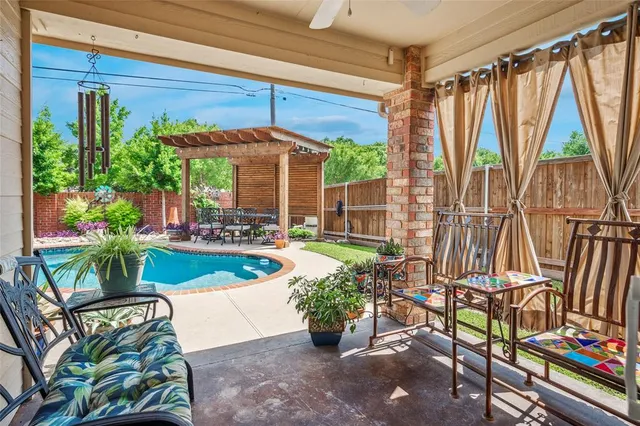 a view of a patio with table and chairs potted plants