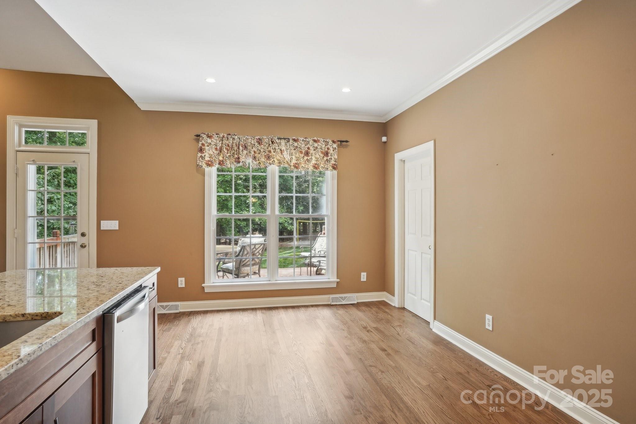 134 Lake Spring Loop Mooresville, NC 28117 - Photo 13 of 36 a view of an empty room with window and wooden floor