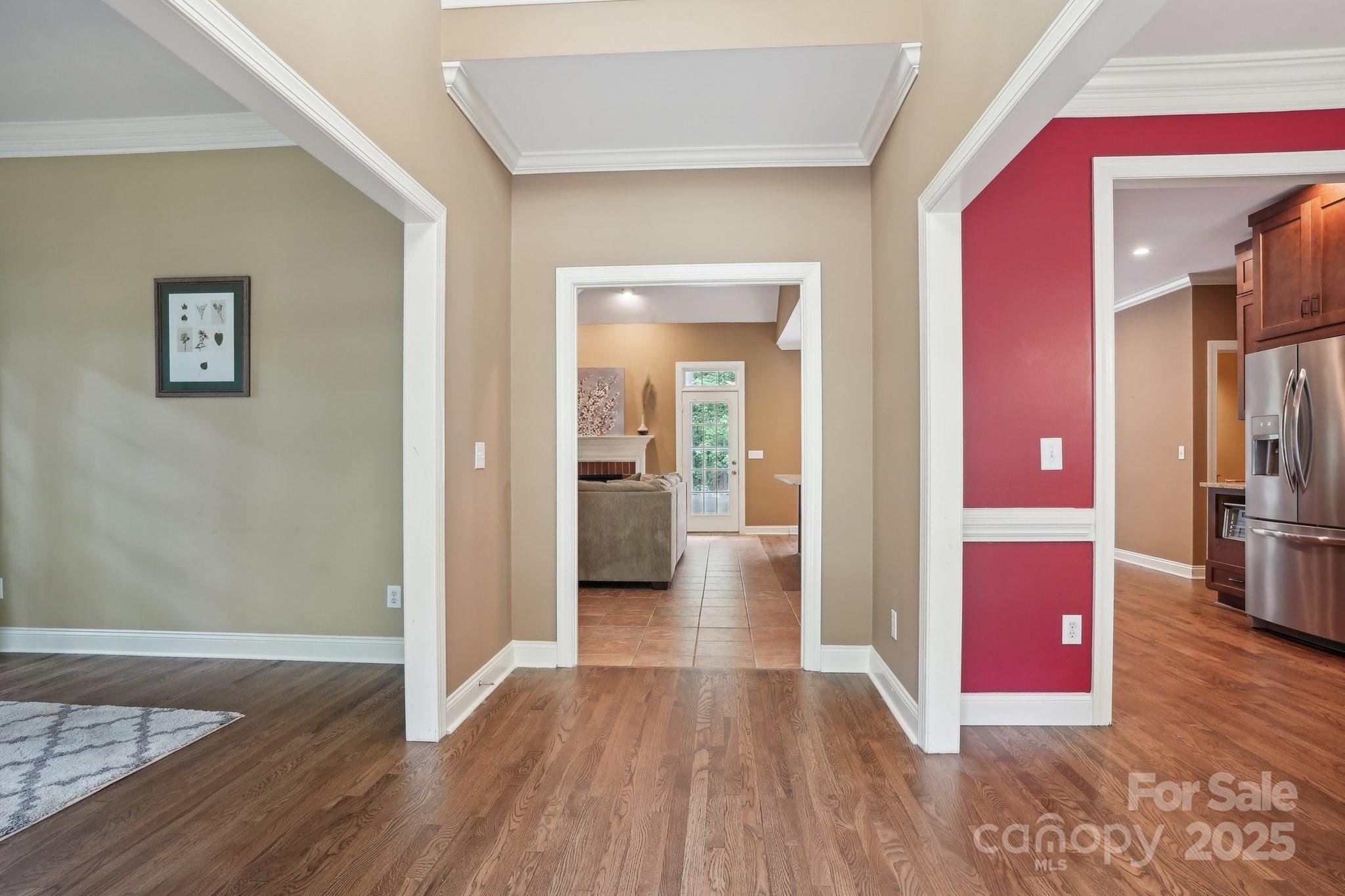 134 Lake Spring Loop Mooresville, NC 28117 - Photo 14 of 36 a view of a hallway with wooden floor windows and a living room