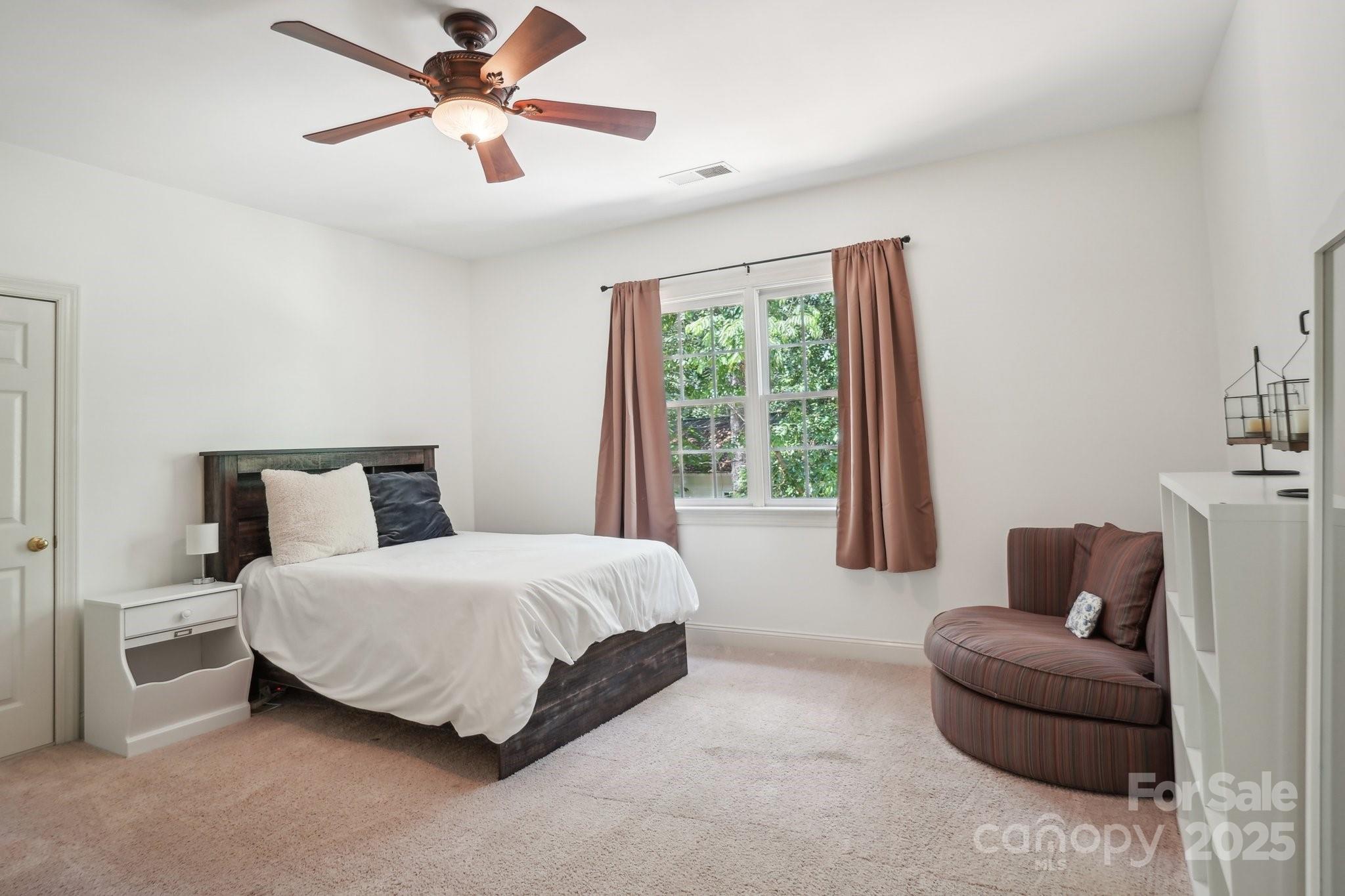 134 Lake Spring Loop Mooresville, NC 28117 - Photo 23 of 36 a bedroom with a bed and a couch