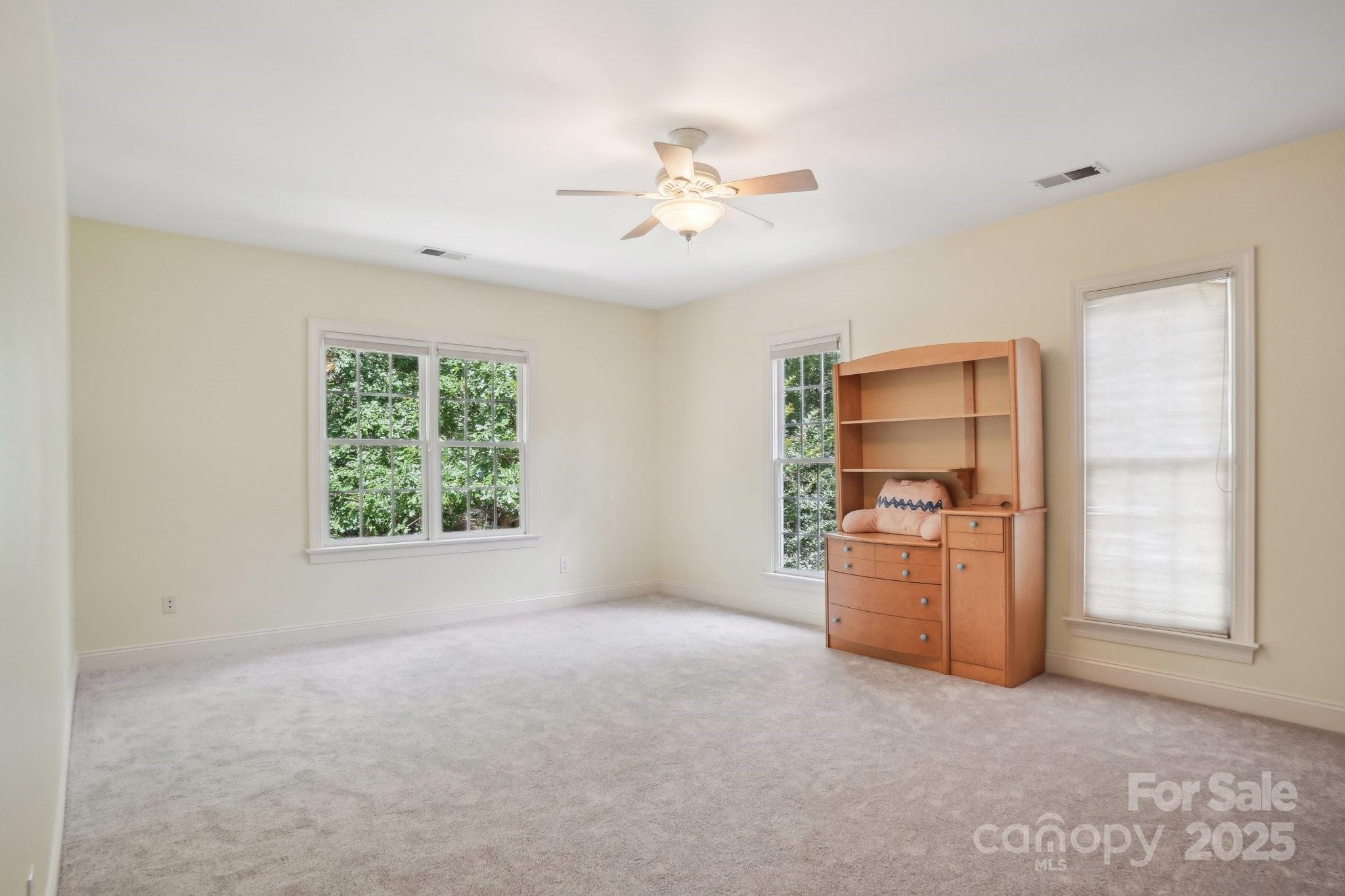 134 Lake Spring Loop Mooresville, NC 28117 - Photo 28 of 36 an empty room with windows and ceiling fan