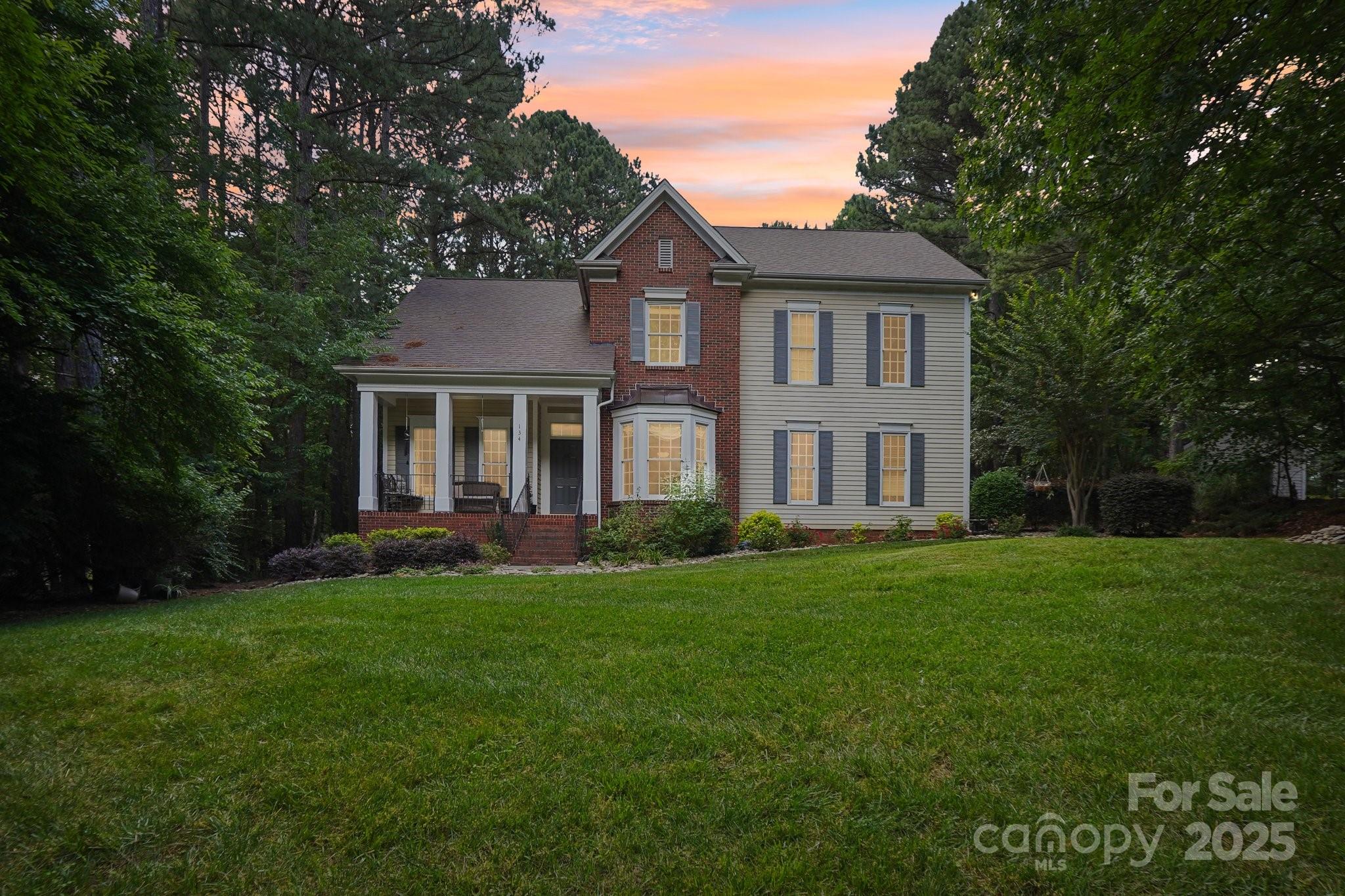 134 Lake Spring Loop Mooresville, NC 28117 - Photo 31 of 36 a front view of a house with a yard and porch