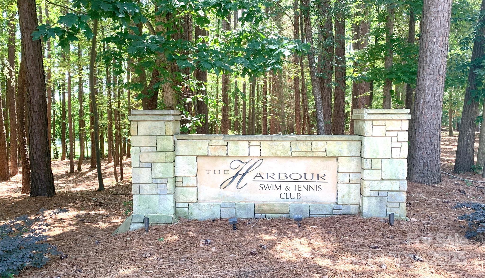 134 Lake Spring Loop Mooresville, NC 28117 - Photo 32 of 36 a view of a park that has large trees and a wooden fence