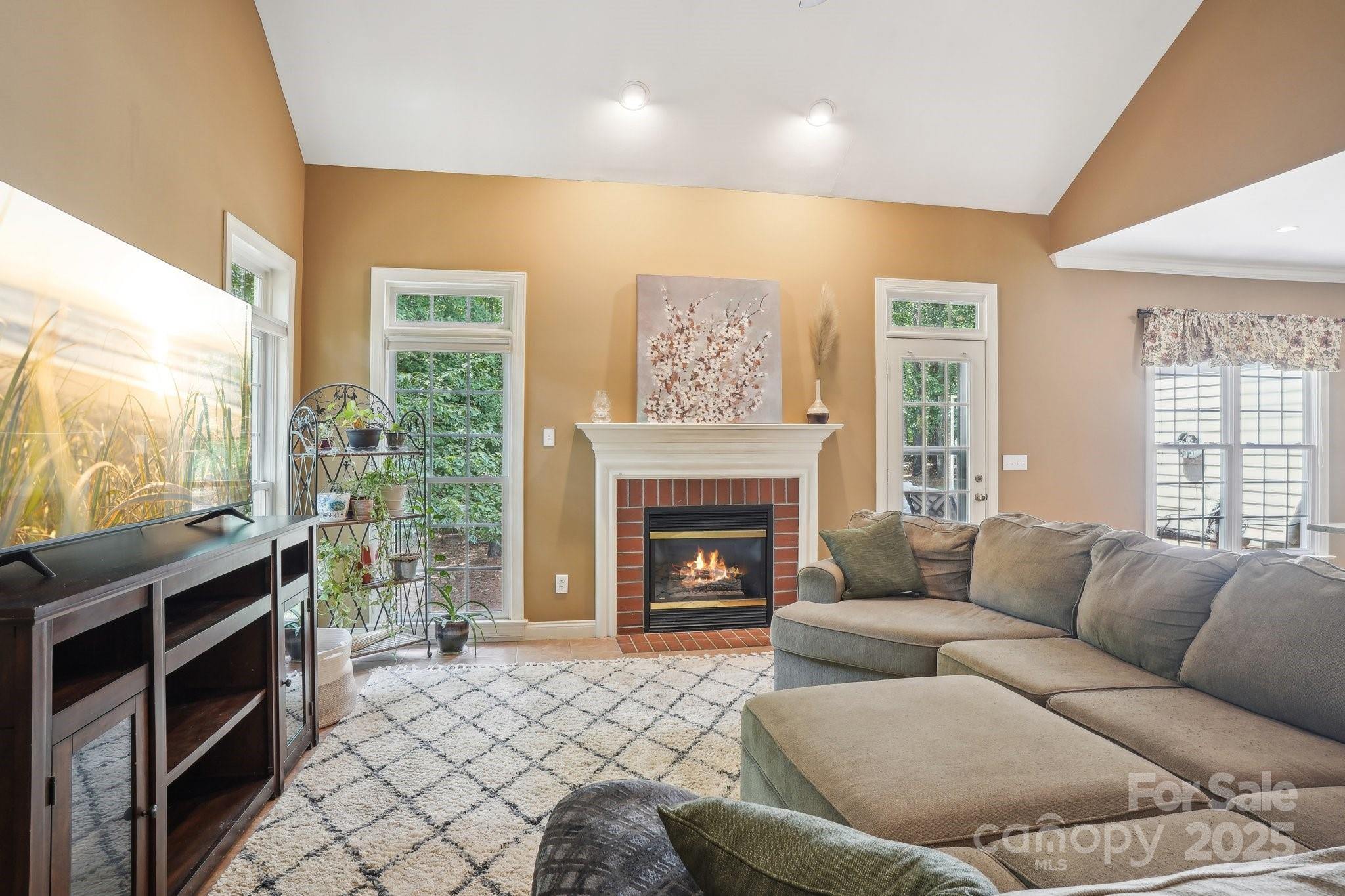 134 Lake Spring Loop Mooresville, NC 28117 - Photo 8 of 36 a living room with furniture a fireplace and a large window