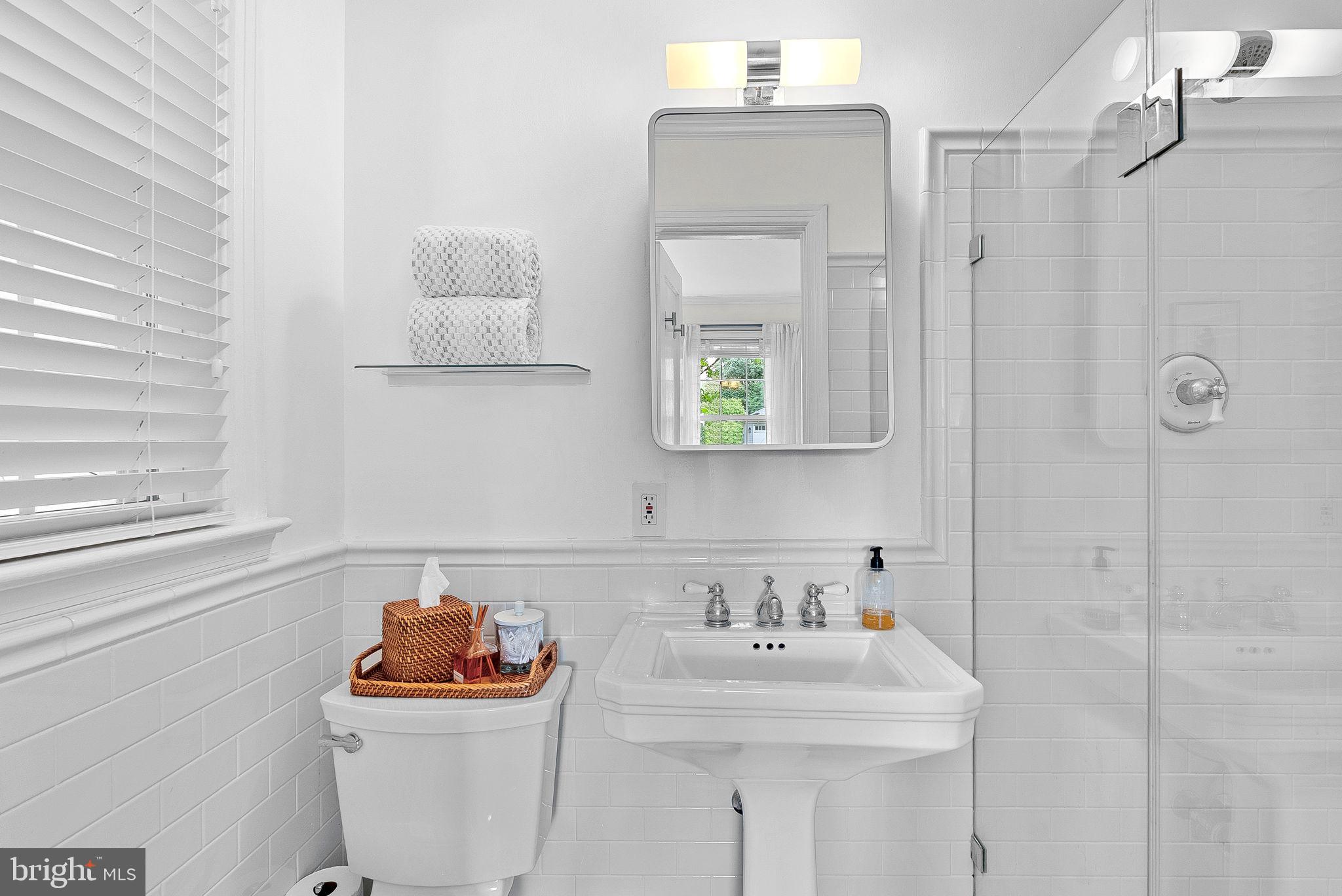 10313 Parkman Road Silver Spring, MD 20903 - Photo 22 of 61 a bathroom with a sink toilet and a mirror