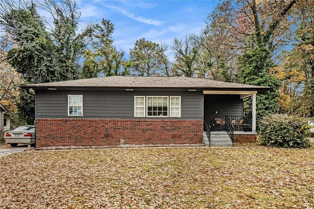 a front view of a house with a garden