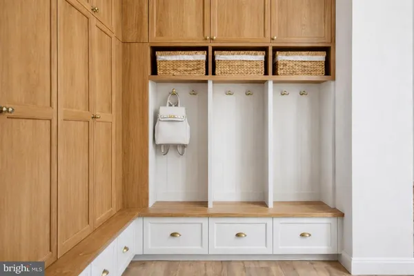 a view of walk in closet with lots of wooden cabinets
