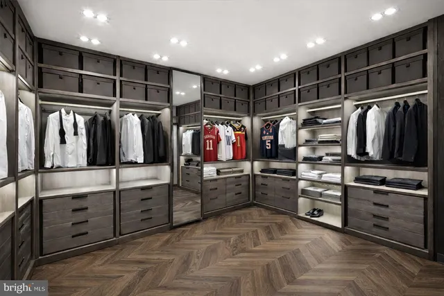 a large white kitchen with cabinets