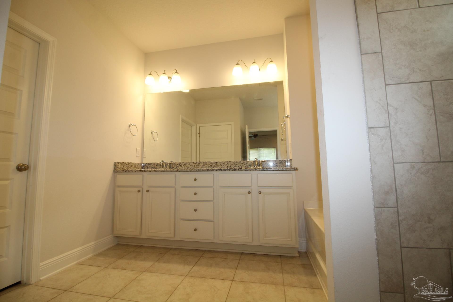 8006 Burnside Loop Pensacola, FL 32526 - Photo 13 of 22 a bathroom with a sink and a mirror