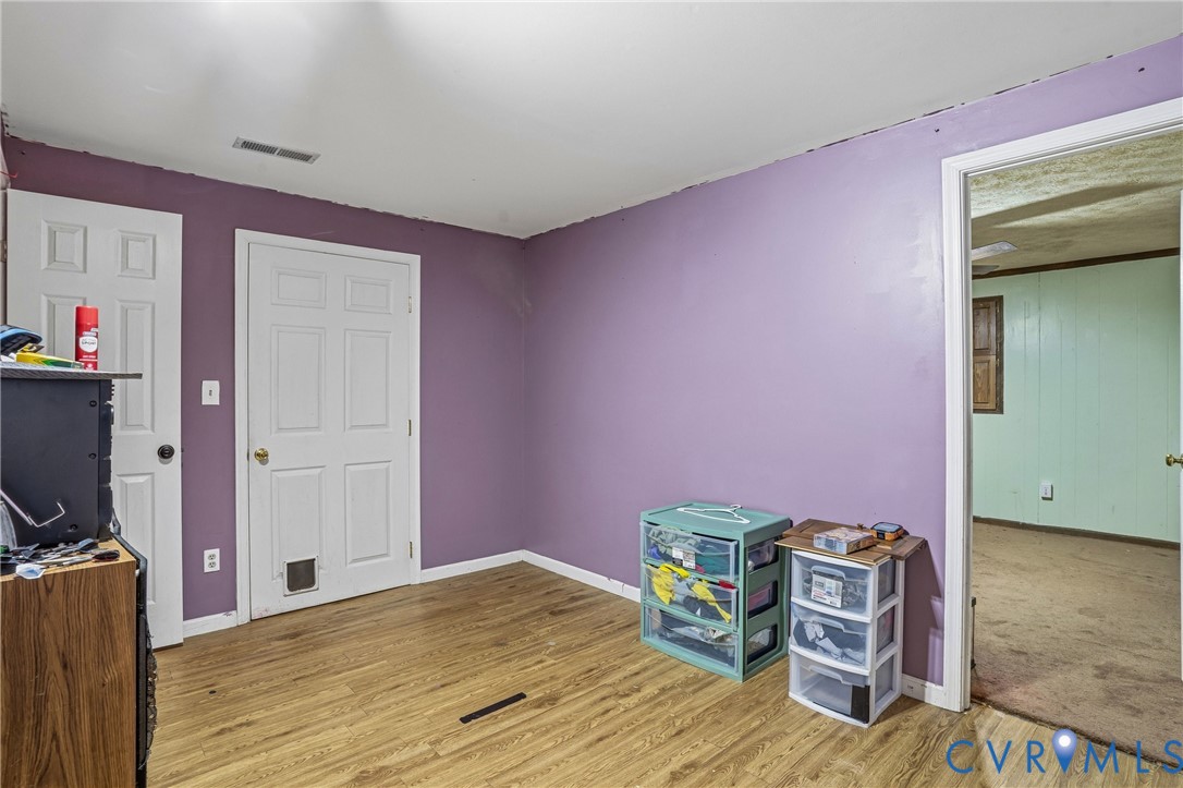 14219 Spruce Avenue Chester, VA 23836 - Photo 22 of 32 a bed room with a bed and a television