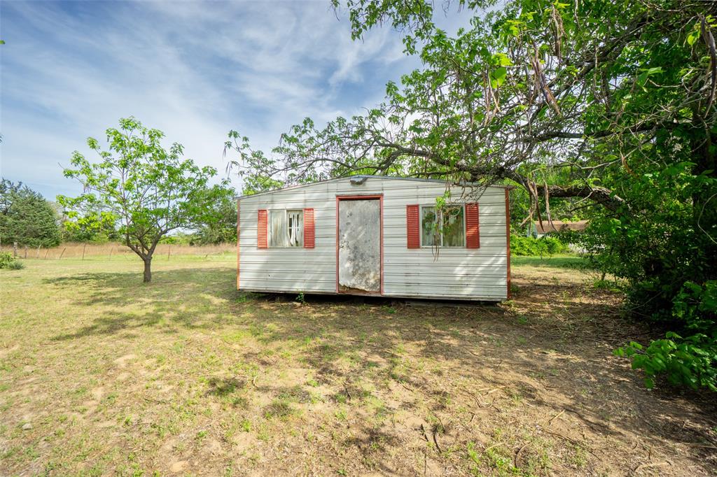 22330 State Highway 64 Canton, TX 75103 - Photo 25 of 33 a view of a backyard with large tree and wooden fence