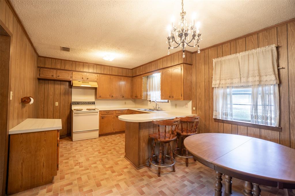 22330 State Highway 64 Canton, TX 75103 - Photo 7 of 33 a kitchen with a table chairs refrigerator and cabinets