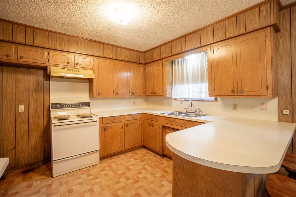 22330 State Highway 64 Canton, TX 75103 - Photo 8 of 33 a kitchen with stainless steel appliances granite countertop a sink a stove a refrigerator with grey cabinets and wooden floor