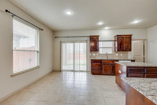 a kitchen with a stove sink and cabinets