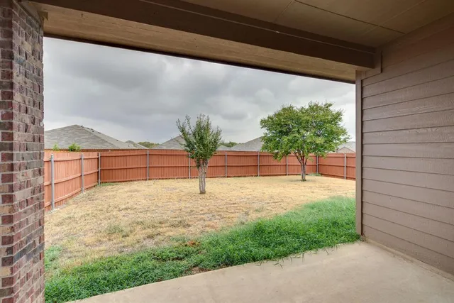 a front view of house with a garden
